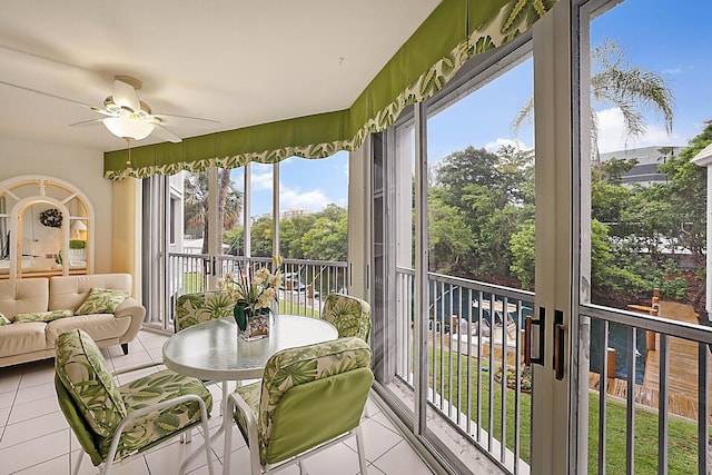 sunroom / solarium featuring ceiling fan