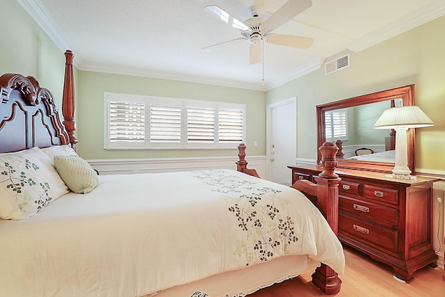 bedroom featuring multiple windows, ceiling fan, and ornamental molding