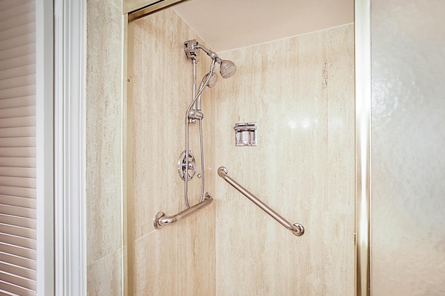 interior details with a tile shower