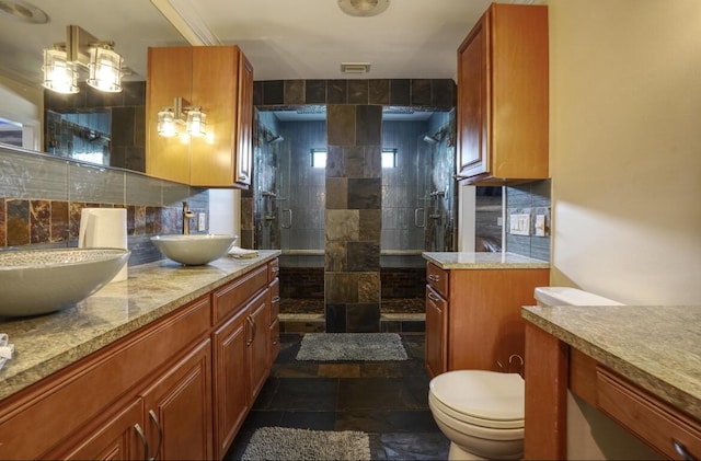 bathroom with vanity, backsplash, toilet, and an enclosed shower