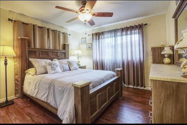 bedroom with ceiling fan and dark wood-type flooring