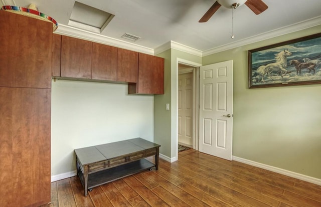 interior space with ceiling fan, dark hardwood / wood-style flooring, and ornamental molding