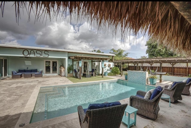 view of pool with french doors, an outdoor hangout area, and a patio area