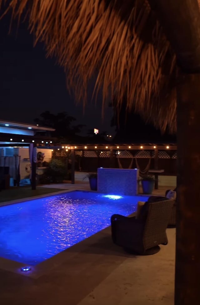 pool at twilight featuring a patio