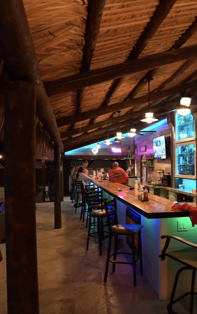 bar with decorative light fixtures and wood ceiling