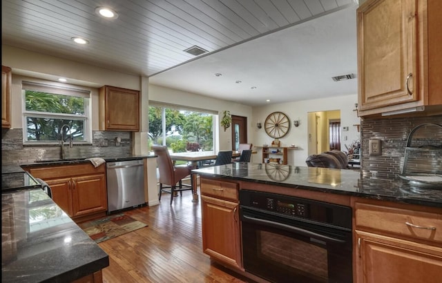 kitchen featuring dishwasher, sink, hardwood / wood-style floors, oven, and wood ceiling