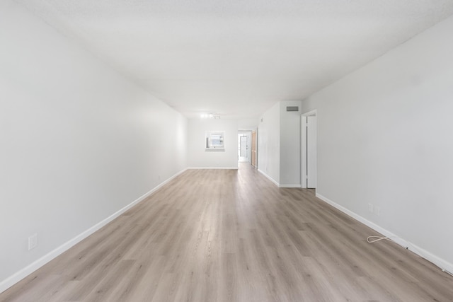 empty room with light hardwood / wood-style flooring