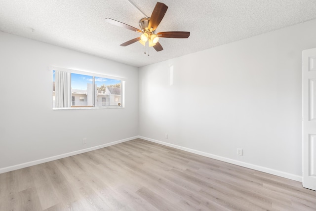 spare room with light wood-type flooring, a textured ceiling, and ceiling fan