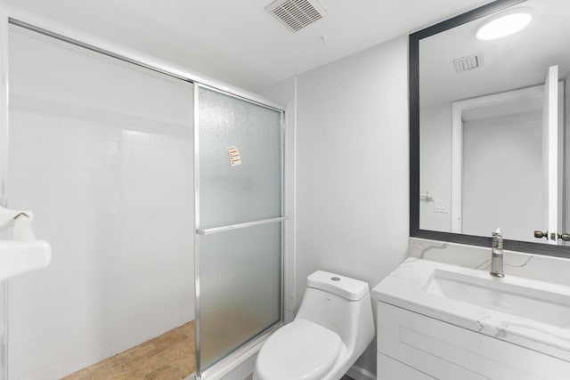 bathroom with vanity, toilet, and walk in shower