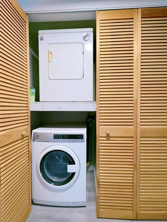 laundry room featuring stacked washer / dryer