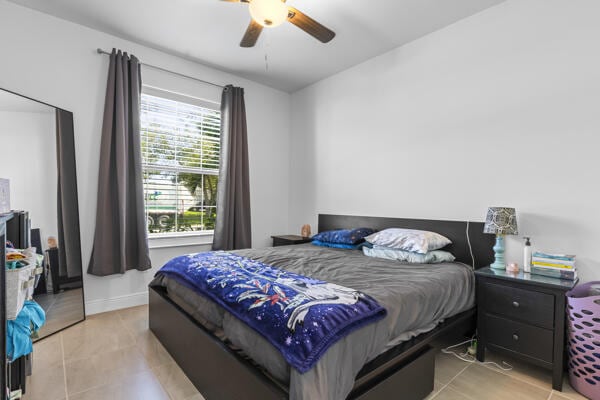 tiled bedroom with ceiling fan