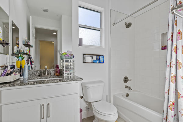 full bathroom with toilet, vanity, and shower / tub combo with curtain