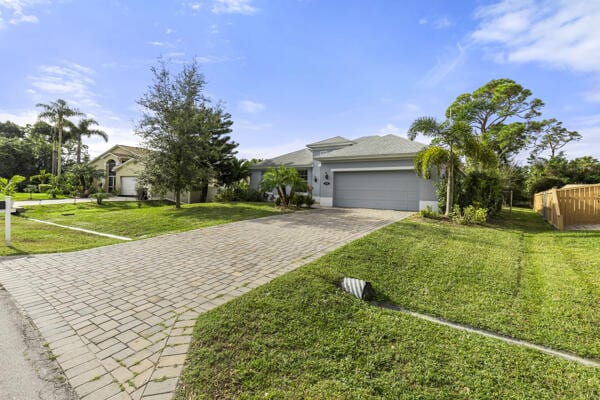 ranch-style home with a front lawn and a garage