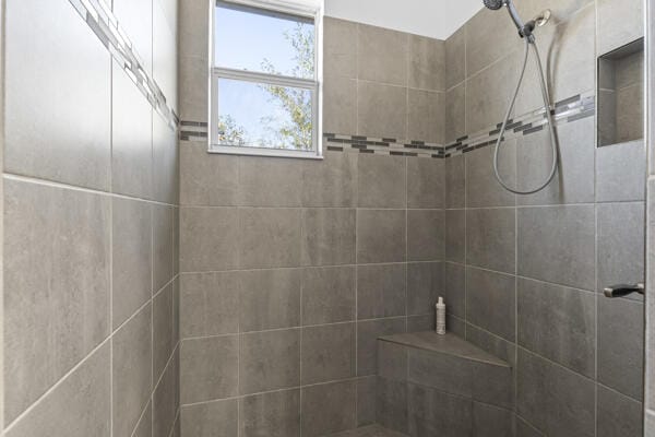 bathroom with tiled shower