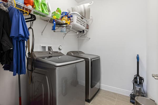 washroom featuring separate washer and dryer and light tile patterned flooring