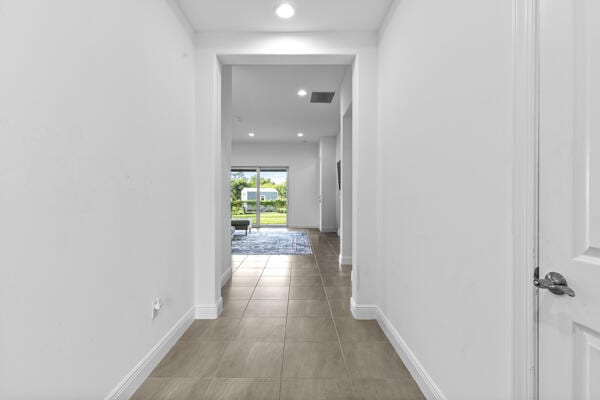 hall with light tile patterned flooring