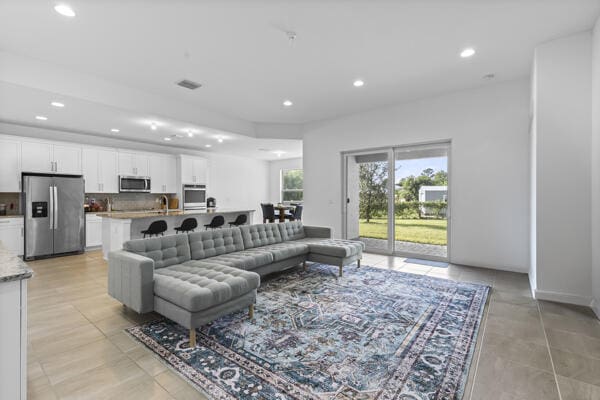 living room featuring light tile patterned floors and sink