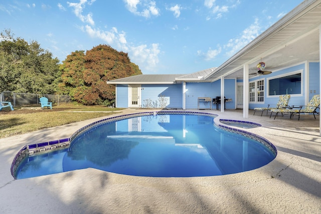 view of swimming pool with a patio area, a fenced in pool, fence, and an in ground hot tub