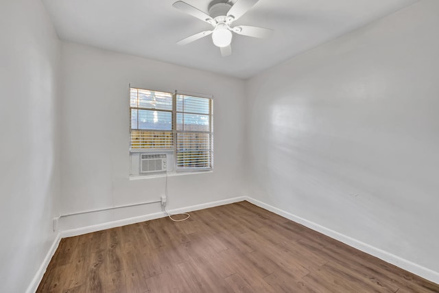 spare room with hardwood / wood-style flooring, cooling unit, and ceiling fan