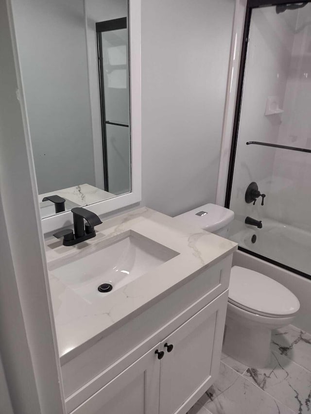 full bathroom featuring vanity, bath / shower combo with glass door, and toilet