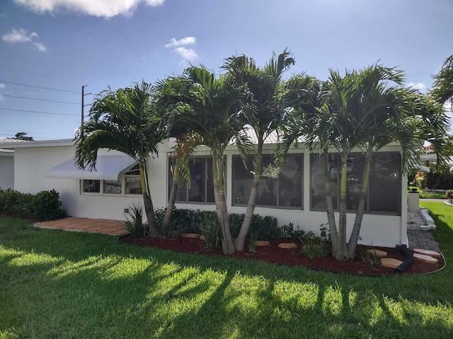 view of side of home featuring a yard