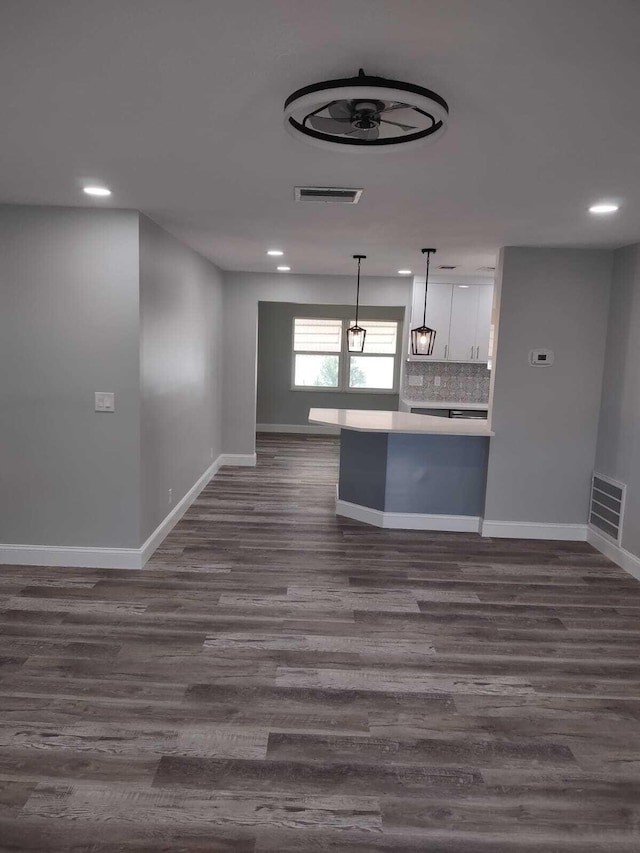 unfurnished living room with dark wood-type flooring