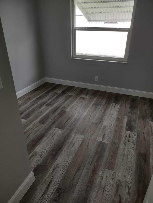 spare room with dark wood-type flooring