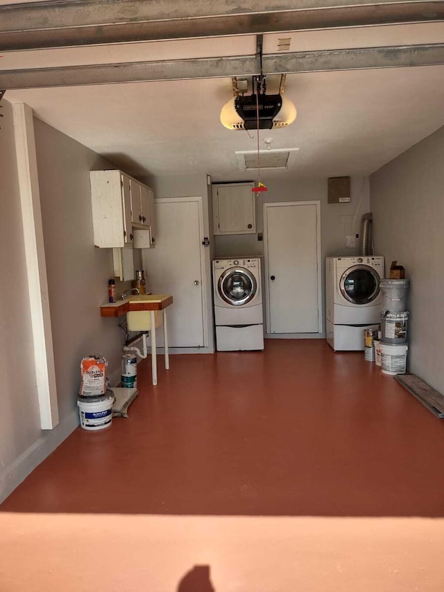 garage with a garage door opener and washer and clothes dryer