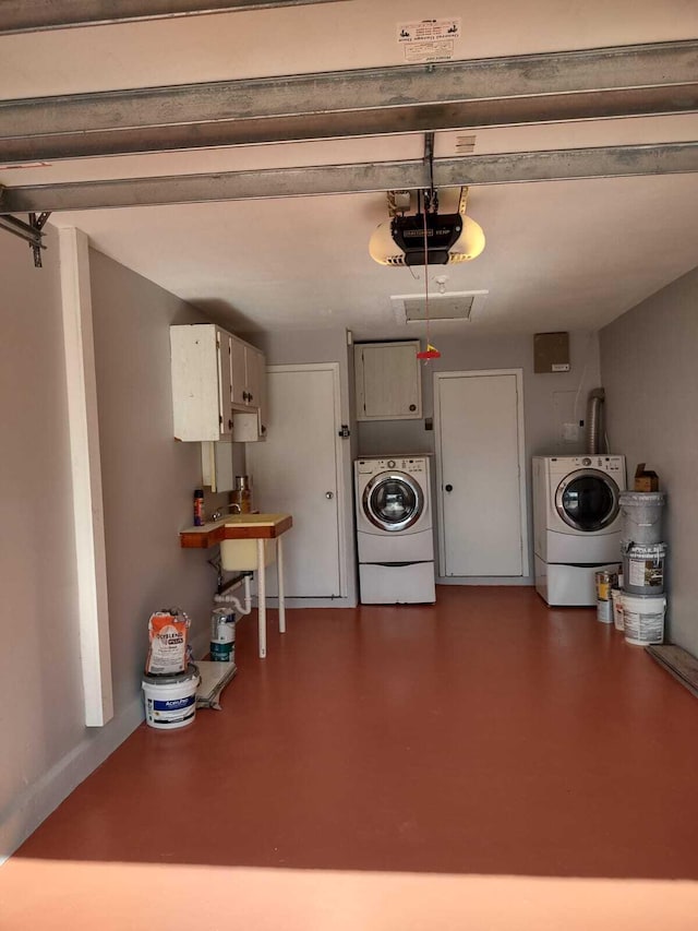 garage with independent washer and dryer and a garage door opener