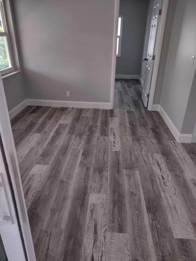 empty room with dark wood-type flooring