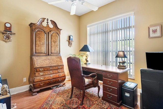 office space featuring ceiling fan and light hardwood / wood-style floors