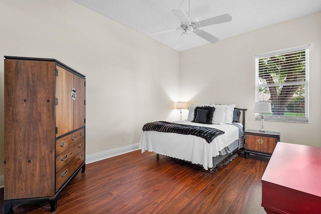 bedroom featuring ceiling fan, dark hardwood / wood-style flooring, and a textured ceiling