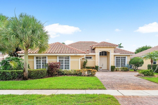 mediterranean / spanish home with a front yard