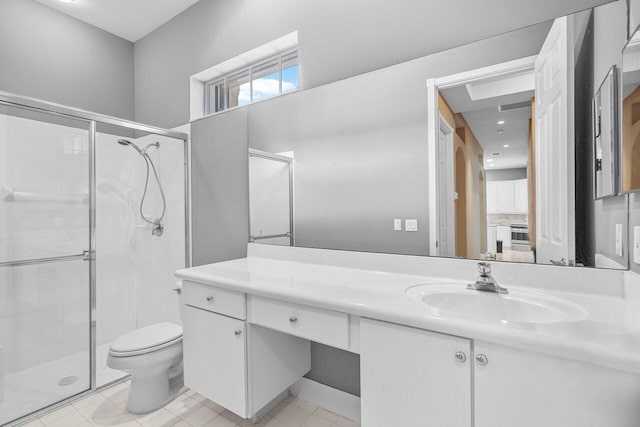 bathroom featuring vanity, toilet, and a shower with shower door