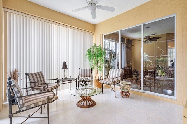 sunroom / solarium featuring ceiling fan