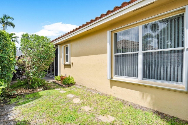 view of property exterior featuring a lawn