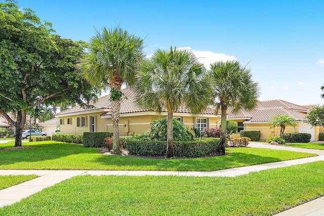 mediterranean / spanish house featuring a front lawn