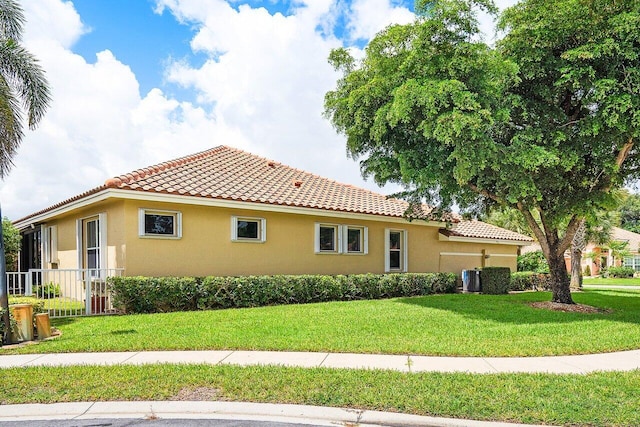 view of side of home with a yard