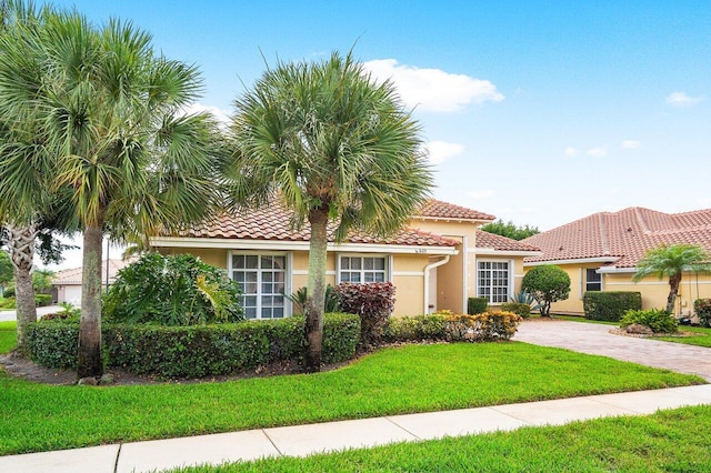 mediterranean / spanish house featuring a front yard