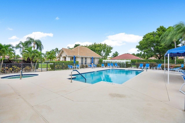 view of swimming pool with a patio and a hot tub