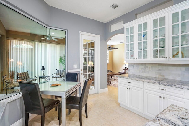 dining area with ceiling fan and light tile patterned floors