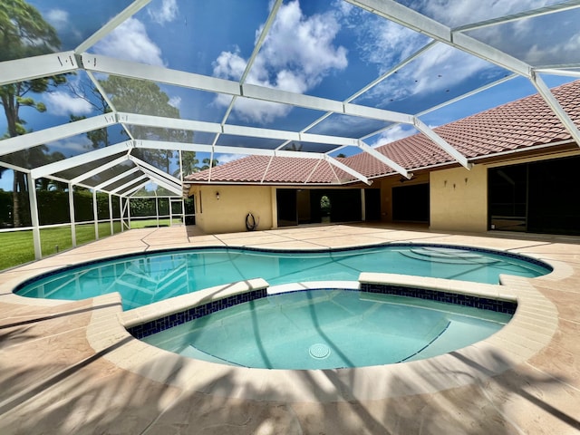 view of swimming pool with a lanai, a patio, and an in ground hot tub