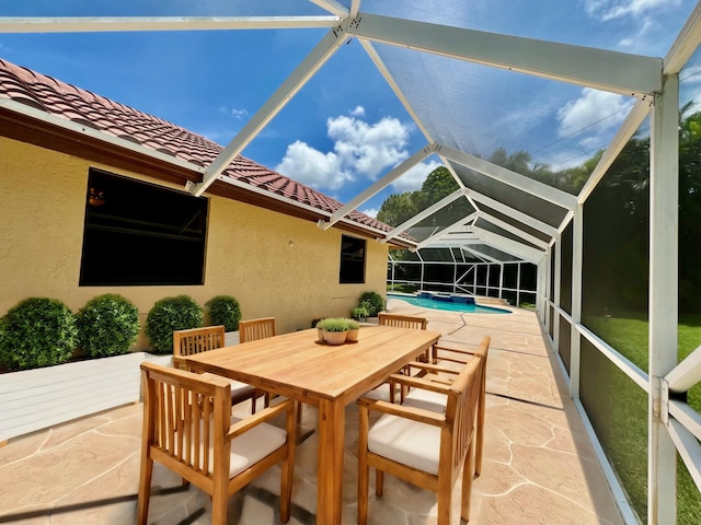 view of patio / terrace featuring a lanai