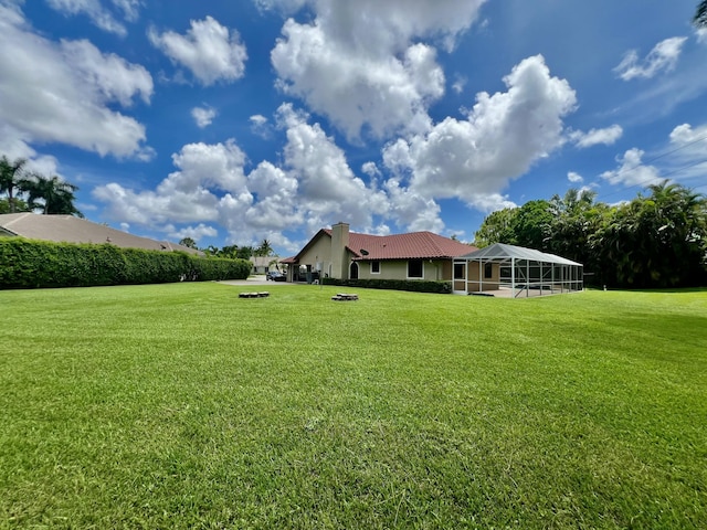 view of yard with a lanai