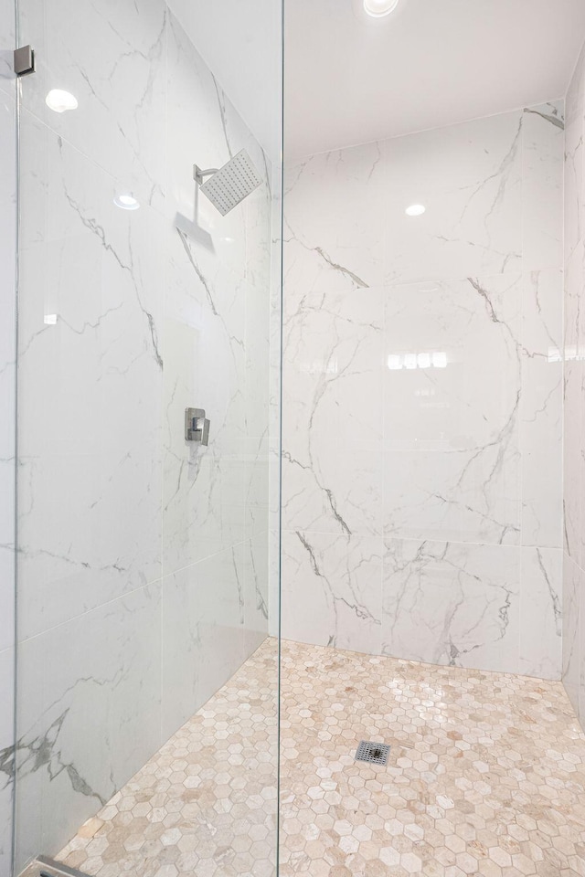 bathroom with a tile shower