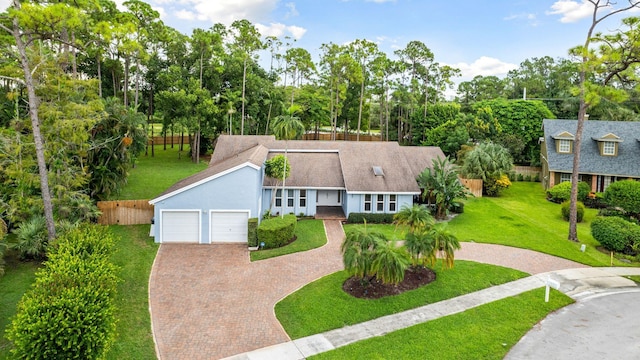 view of front of house with a garage and a front lawn