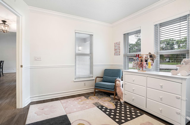 sitting room with dark hardwood / wood-style flooring and ornamental molding