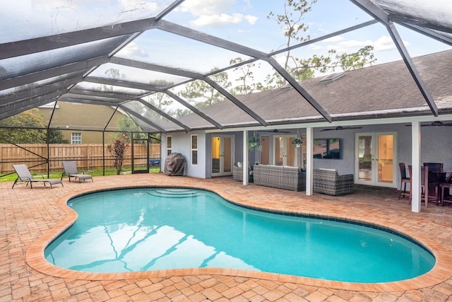 view of pool featuring grilling area, french doors, ceiling fan, a lanai, and a patio area