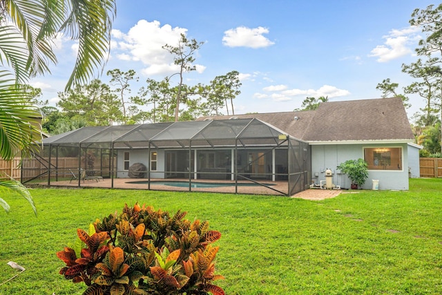 back of property featuring a lanai, a fenced in pool, a yard, and a patio