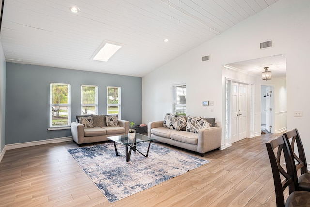 living room featuring vaulted ceiling with skylight, wooden ceiling, and light wood-type flooring